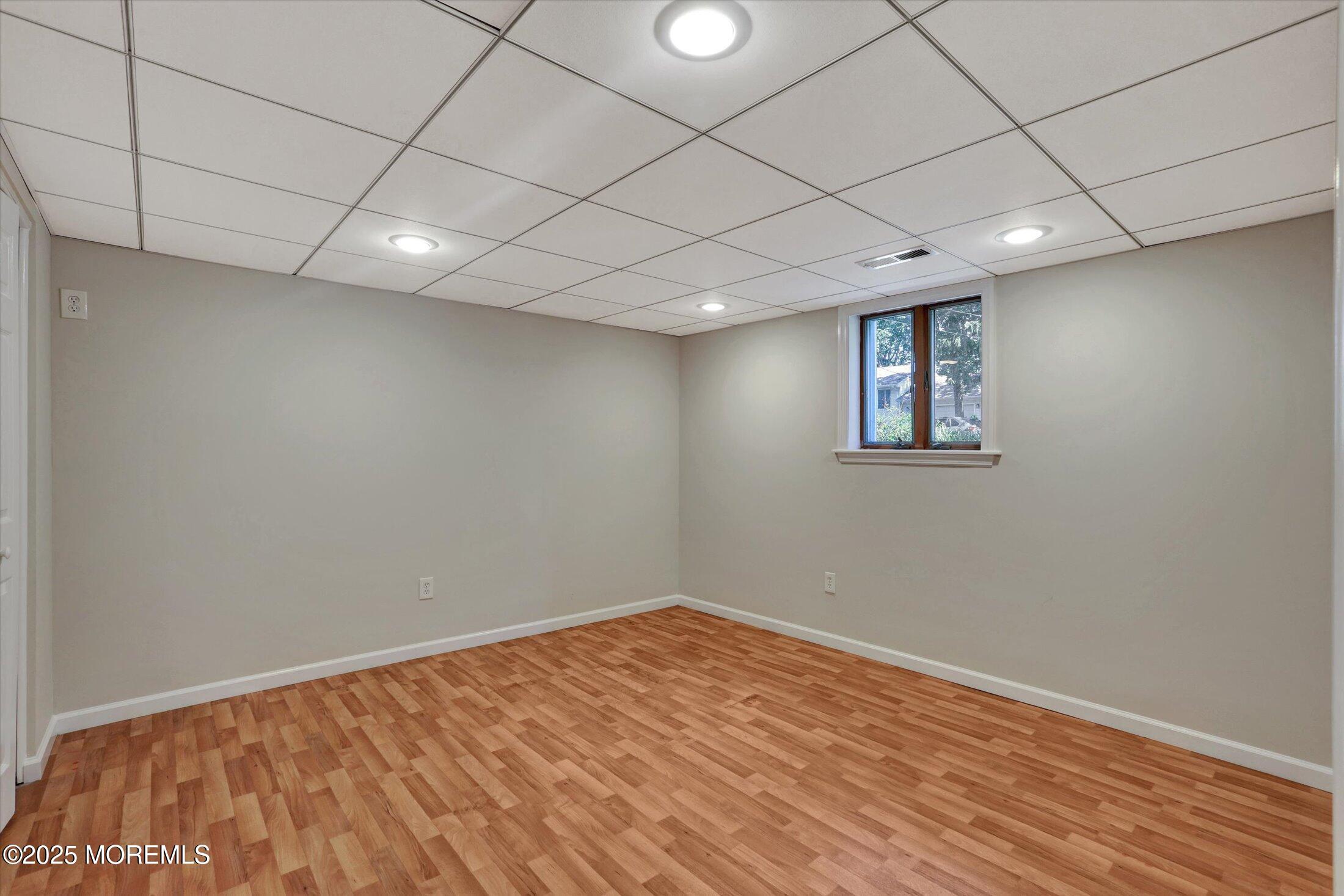 23 Princeton Drive Howell, NJ 07731 - Photo 20 of 32 a view of empty room with wooden floor