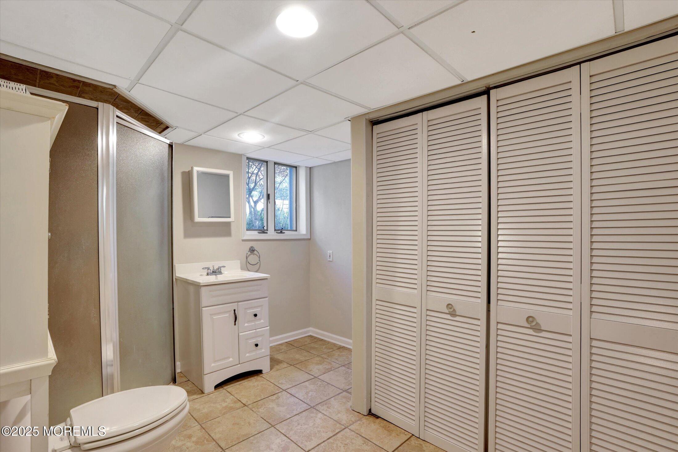 23 Princeton Drive Howell, NJ 07731 - Photo 21 of 32 a bathroom with a toilet a sink and mirror