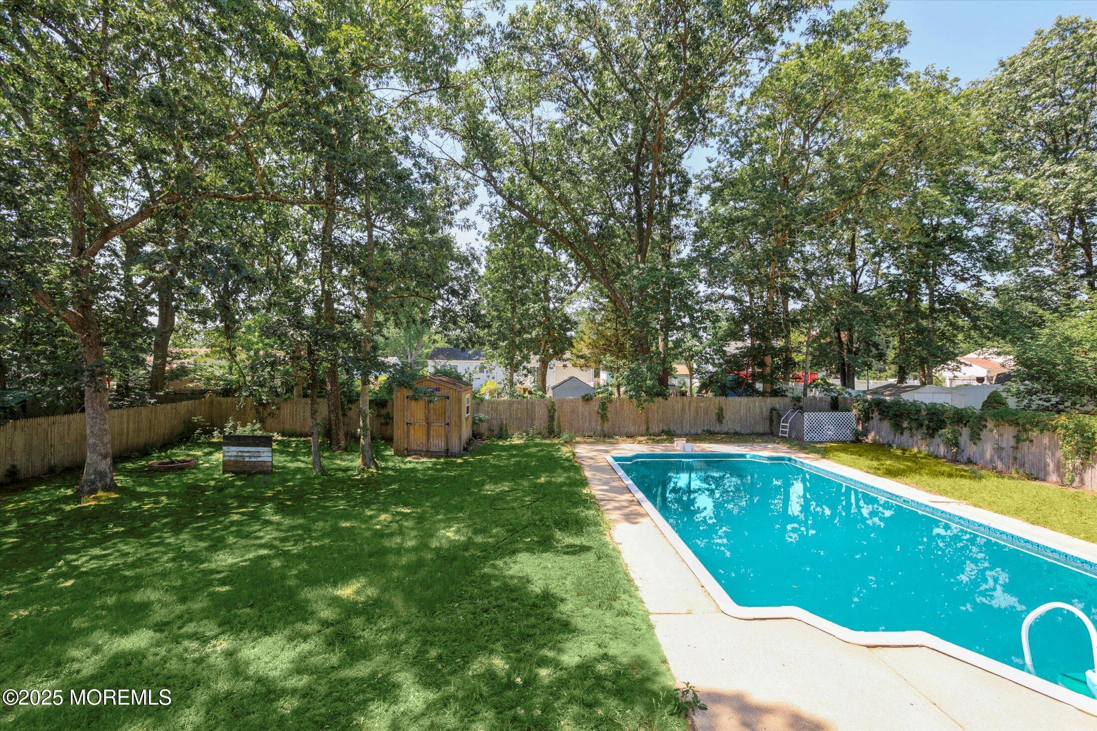 23 Princeton Drive Howell, NJ 07731 - Photo 25 of 32 a view of a swimming pool with a patio and a yard