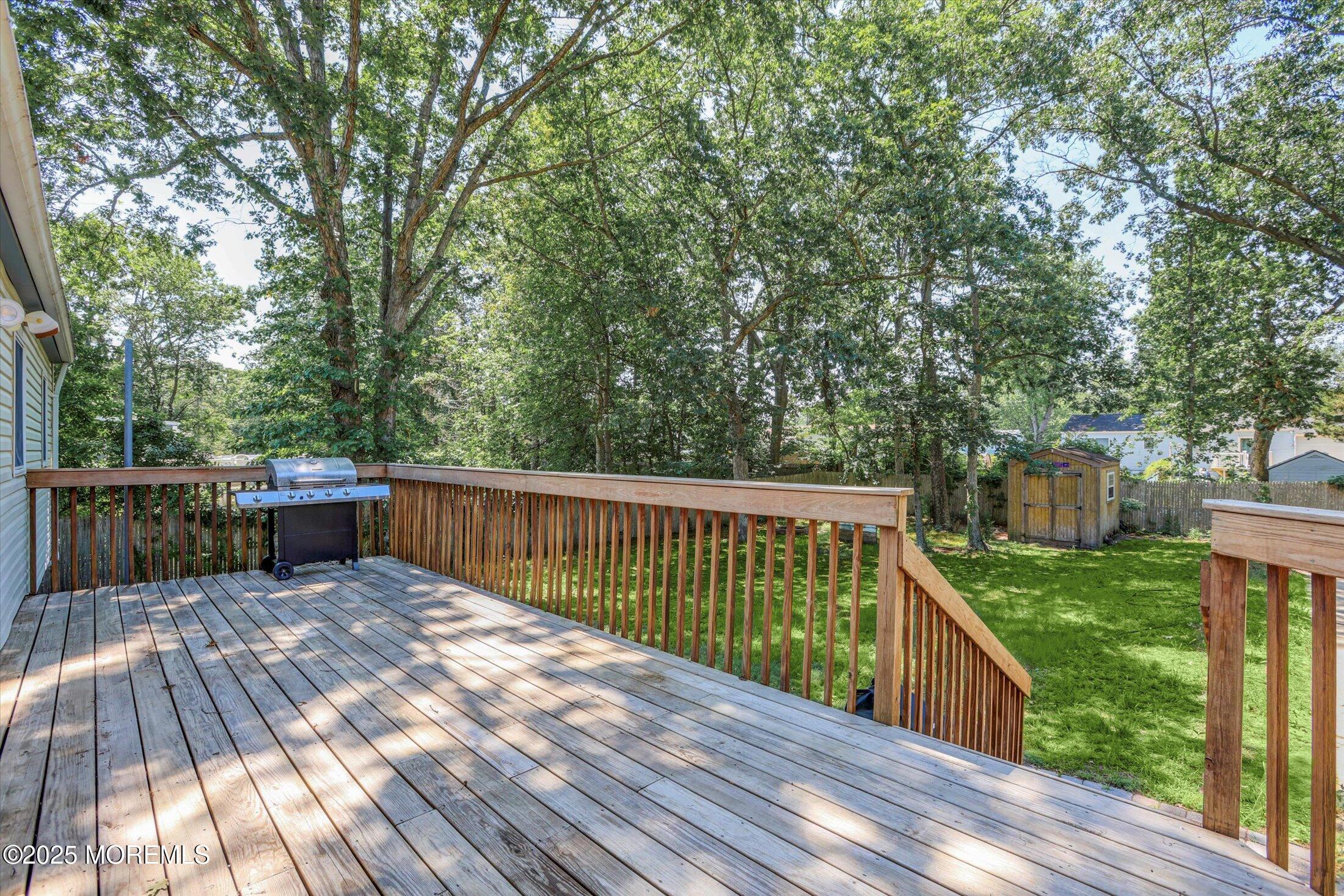 23 Princeton Drive Howell, NJ 07731 - Photo 27 of 32 a view of balcony with deck and wooden floor