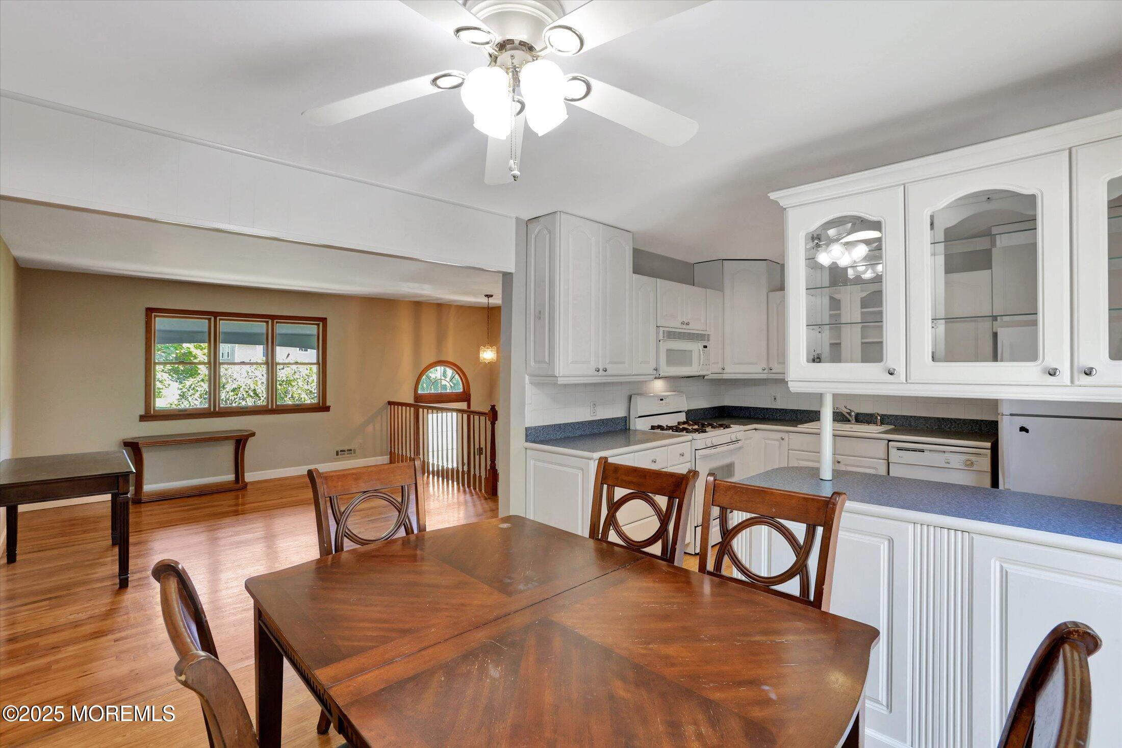 23 Princeton Drive Howell, NJ 07731 - Photo 5 of 32 a view of a dining room with furniture a chandelier and wooden floor