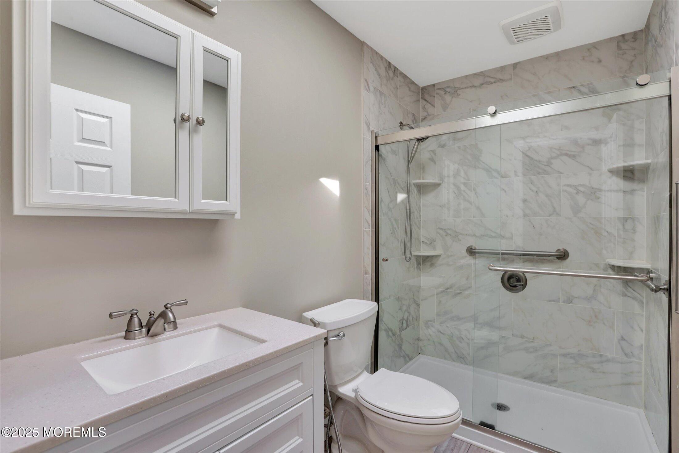23 Princeton Drive Howell, NJ 07731 - Photo 9 of 32 a bathroom with a sink toilet a mirror and shower