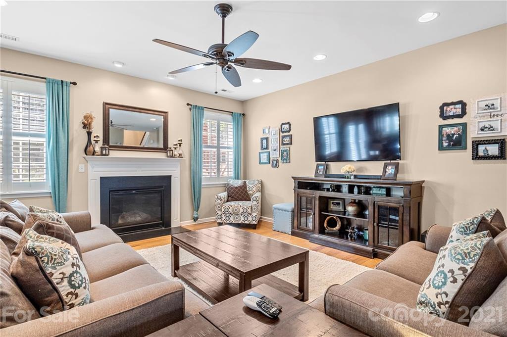 88 Roanoke Road Fletcher, NC 28732 - Photo 8 of 34 a living room with furniture a fireplace and a flat screen tv