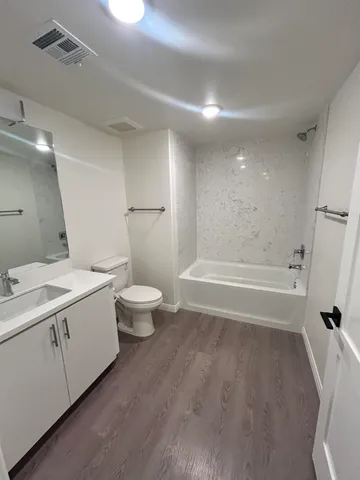 a hallway with wooden floor and windows