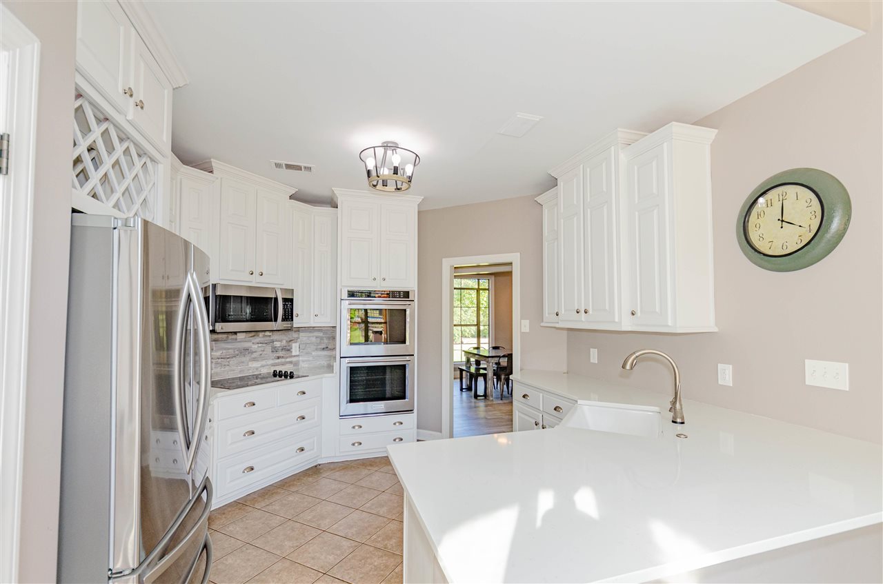 9487 Osborn Road Arlington, TN 38002 - Photo 8 of 23 a kitchen with stainless steel appliances a refrigerator sink and cabinets