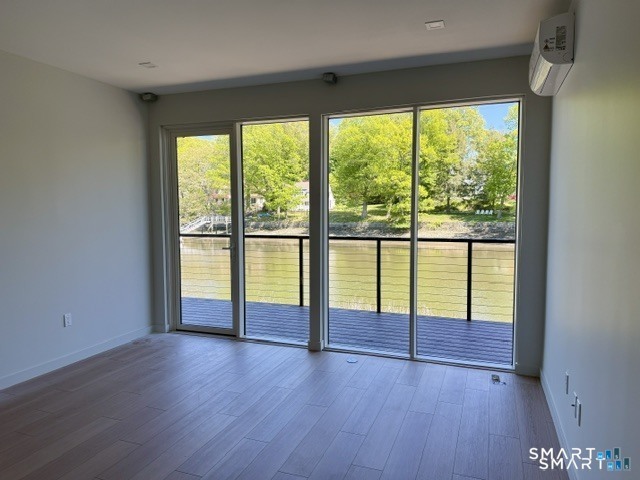 253 Riverside Avenue, Unit 202 Westport, CT 06880 - Photo 9 of 19 a view of empty room with wooden floor and fan