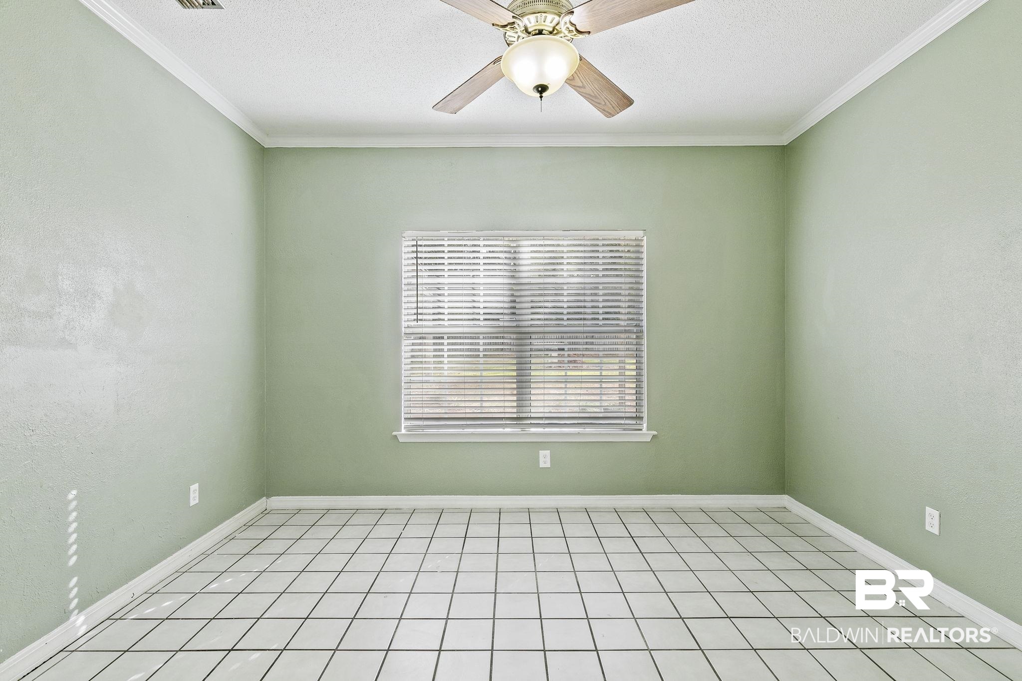 474 Ridgewood Drive Daphne, AL 36526 - Photo 17 of 57 Tiled empty room featuring ceiling fan and ornamental molding