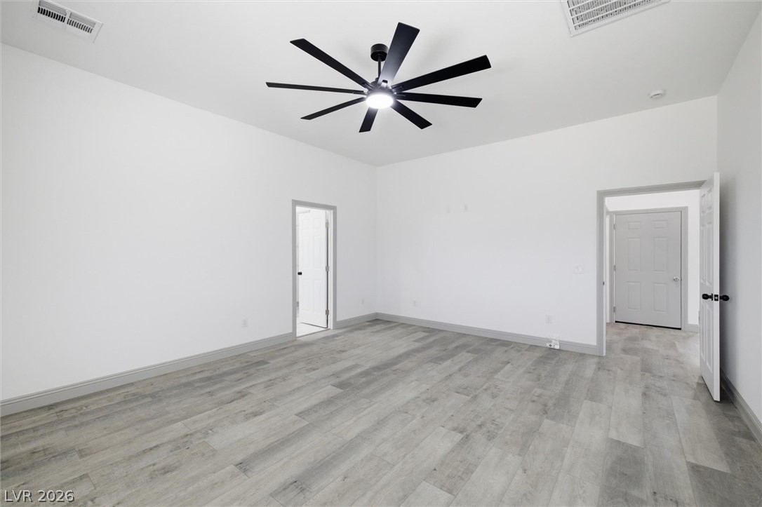 1061 Factory Road Pahrump, NV 89048 - Photo 25 of 41 A well-lit bedroom features cool-toned flooring and a contemporary ceiling fan for year-round comfort.