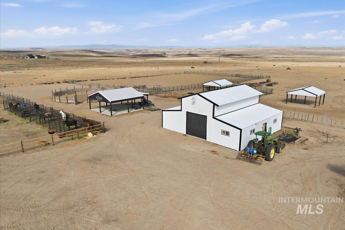 18026 Briar Creek Road Murphy, ID 83650 - Photo 45 of 50 Expansive property featuring a residence with a dark roof, multiple outbuildings, fenced enclosures, and a circular pen