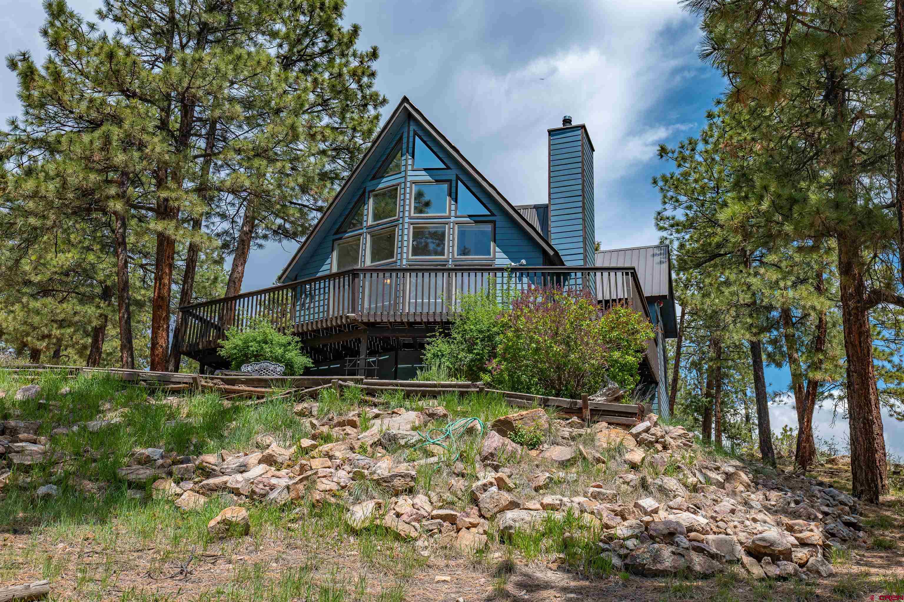 177 Spur Lane Durango, CO 81301 - Photo 1 of 34 a front view of a house with a yard