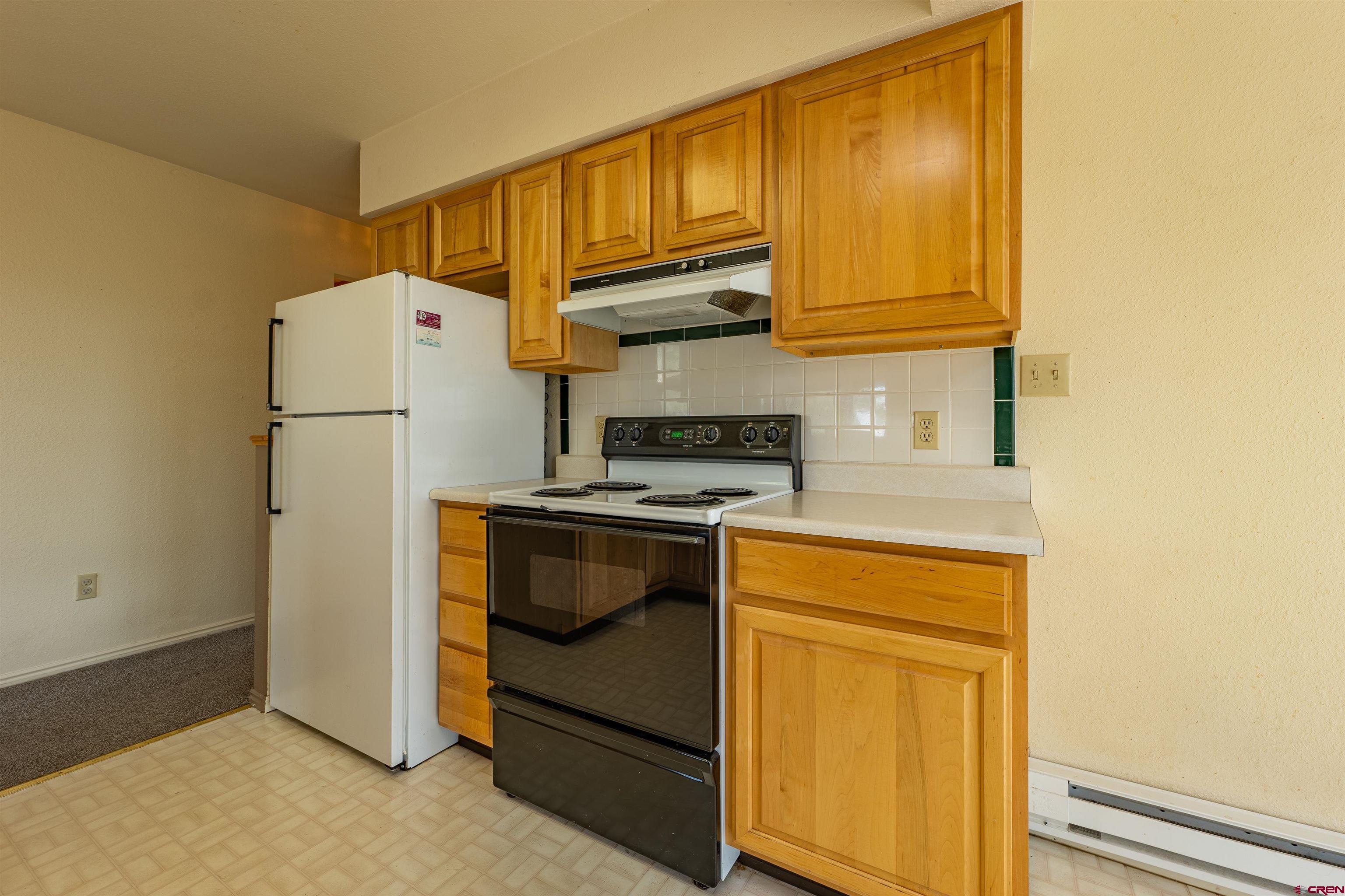 177 Spur Lane Durango, CO 81301 - Photo 11 of 34 a kitchen with a refrigerator and a stove