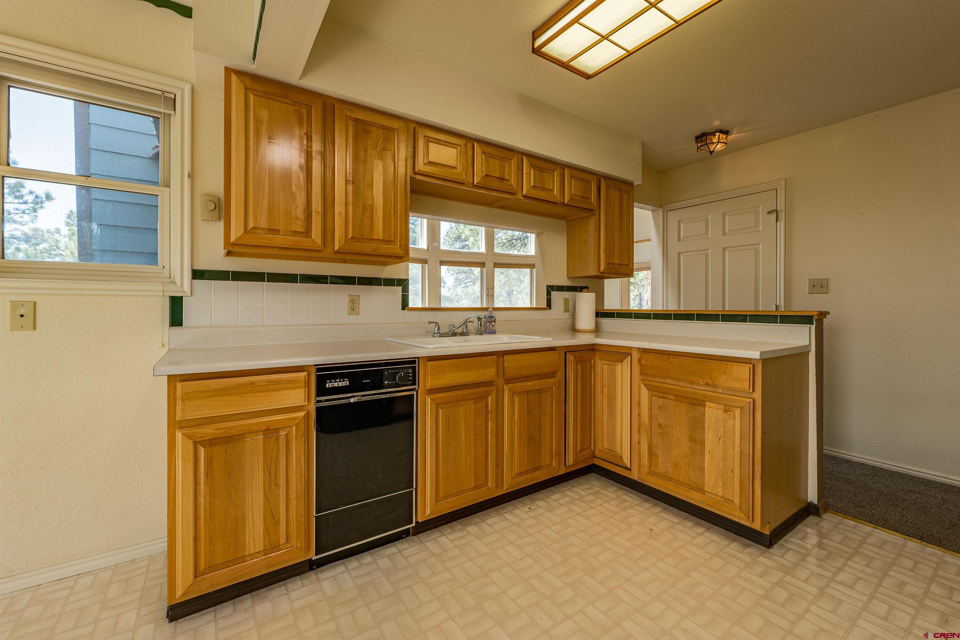 177 Spur Lane Durango, CO 81301 - Photo 12 of 34 a kitchen with granite countertop cabinets stainless steel appliances a sink and a window