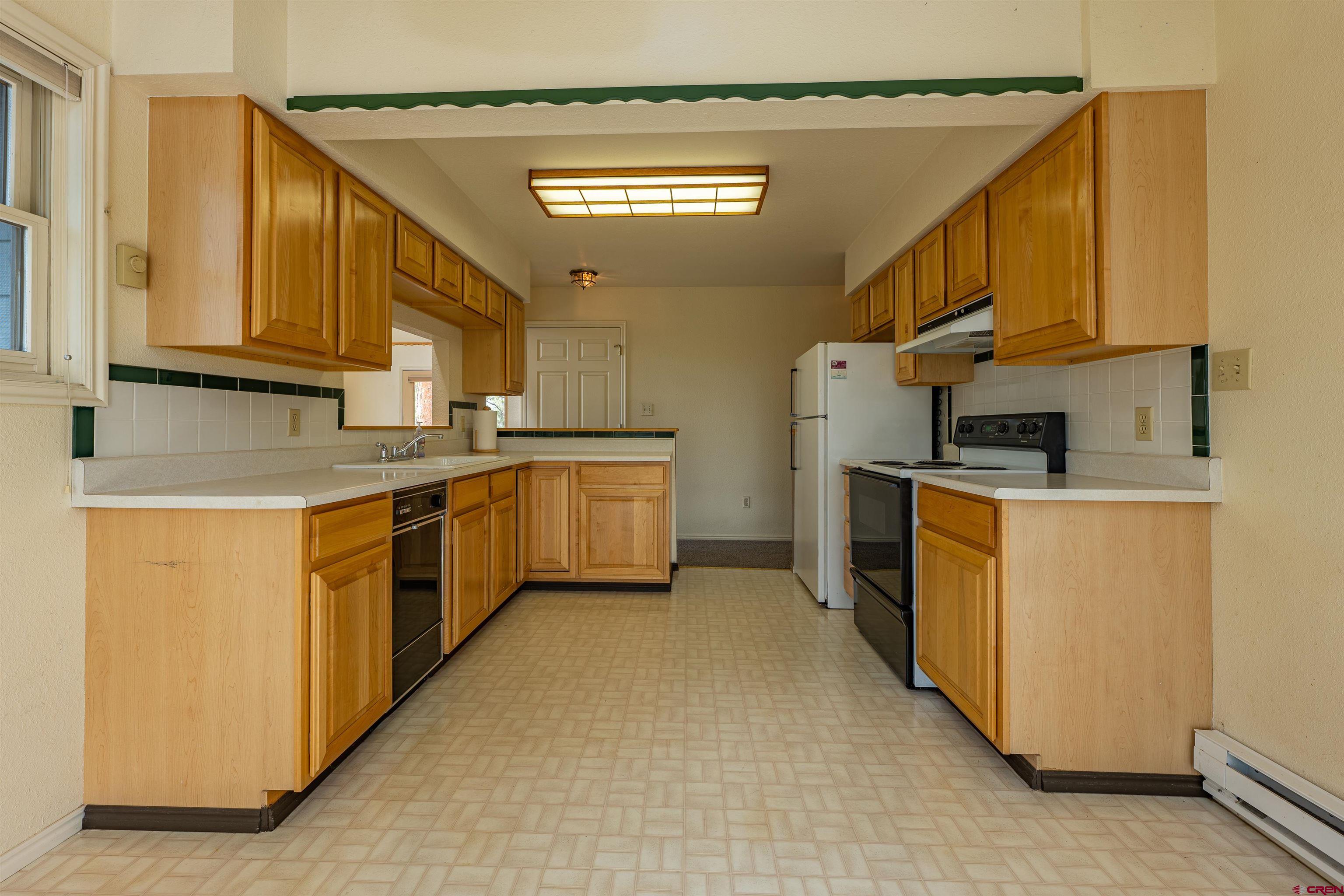 177 Spur Lane Durango, CO 81301 - Photo 13 of 34 a kitchen with stainless steel appliances granite countertop a sink a stove and a refrigerator
