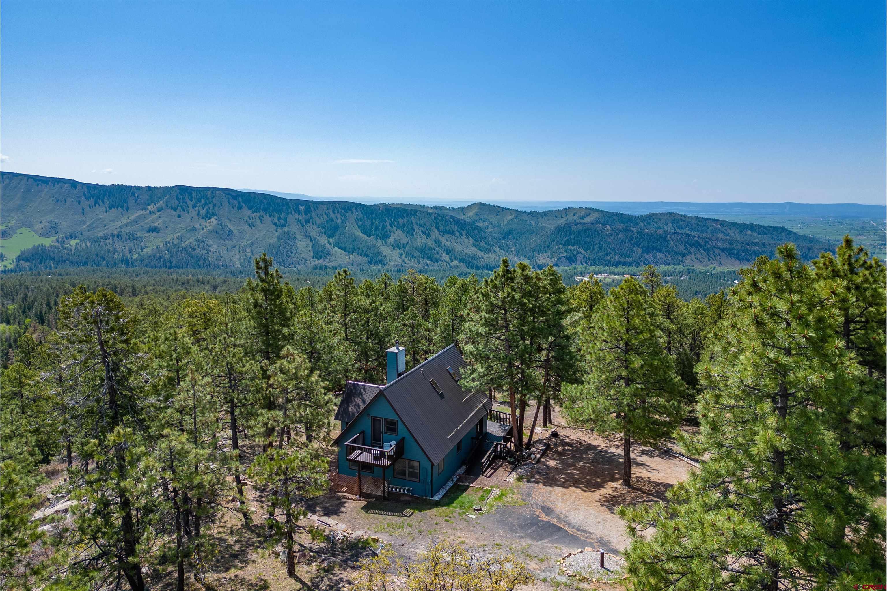 177 Spur Lane Durango, CO 81301 - Photo 2 of 34 a view of a two room with a forest