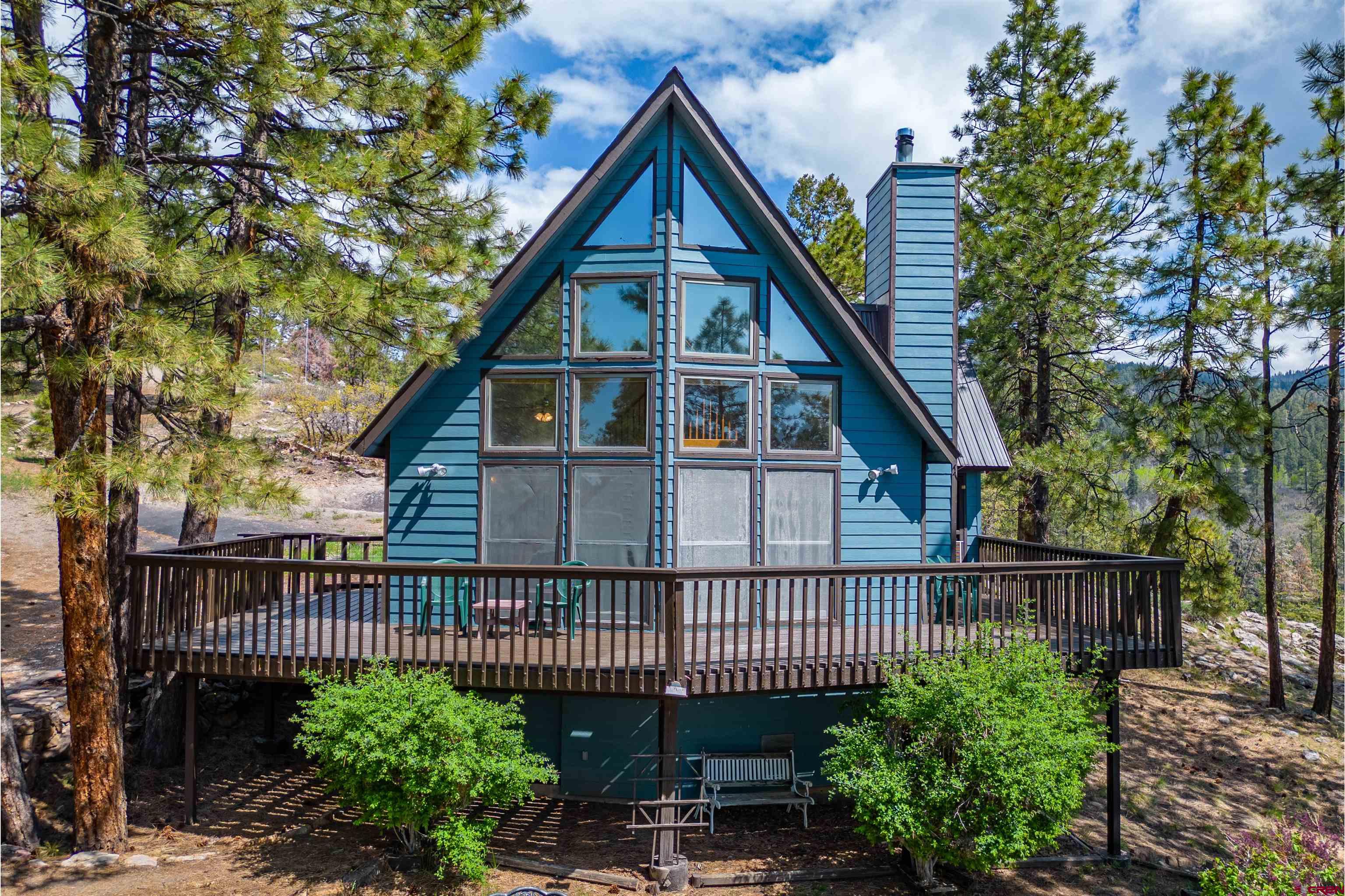 177 Spur Lane Durango, CO 81301 - Photo 3 of 34 a view of a house with a small yard and a garden