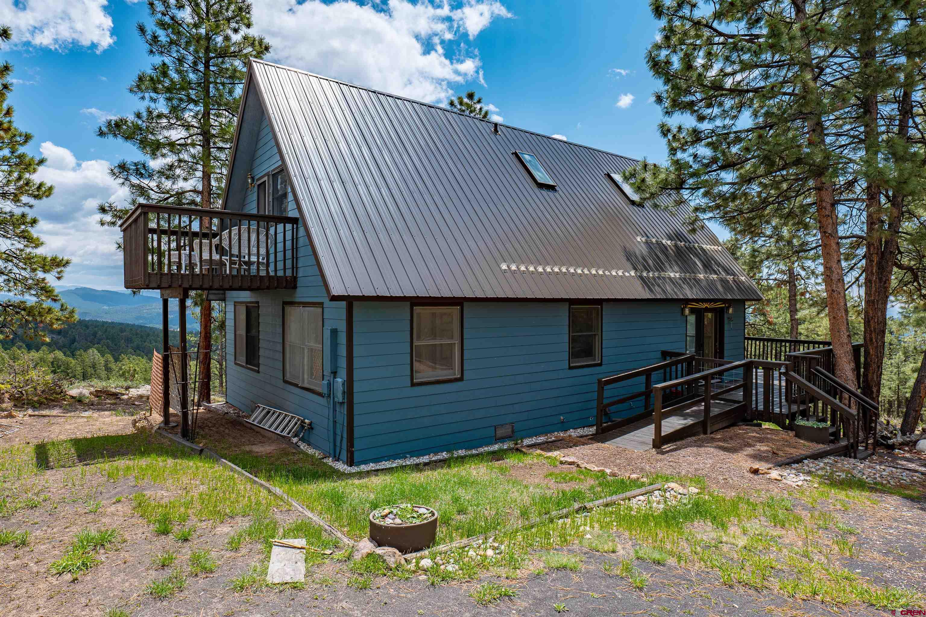 177 Spur Lane Durango, CO 81301 - Photo 33 of 34 a front view of a house with yard and seating area
