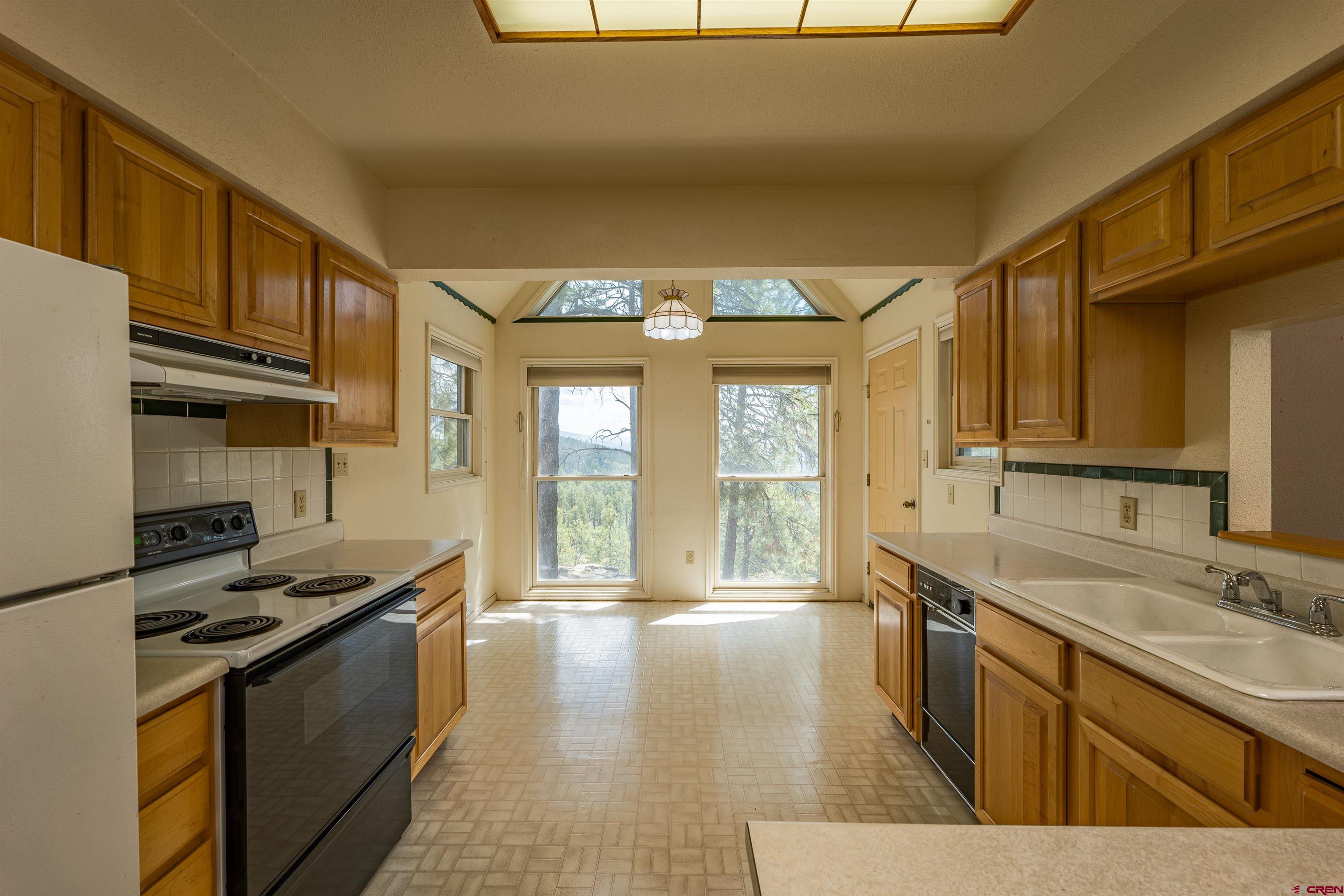 177 Spur Lane Durango, CO 81301 - Photo 10 of 34 a kitchen with stainless steel appliances granite countertop a sink stove and cabinets