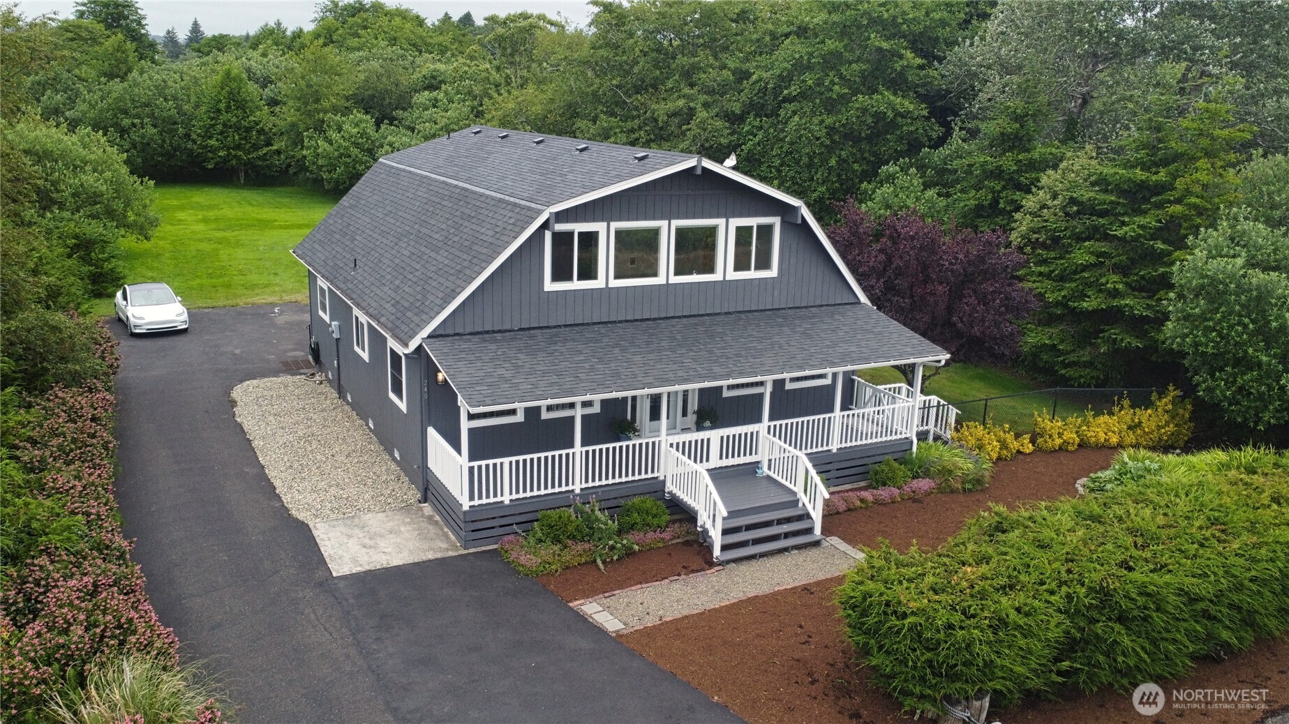 240 Stringtown Road Ilwaco, WA 98624 - Photo 32 of 39 a aerial view of a house with a yard table and chairs