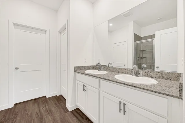a bathroom with a glass shower door