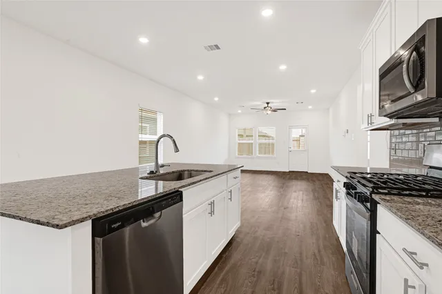 a kitchen with a refrigerator and cabinets