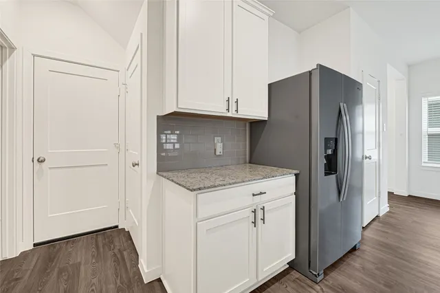 a kitchen with stainless steel appliances granite countertop a stove a refrigerator and a microwave