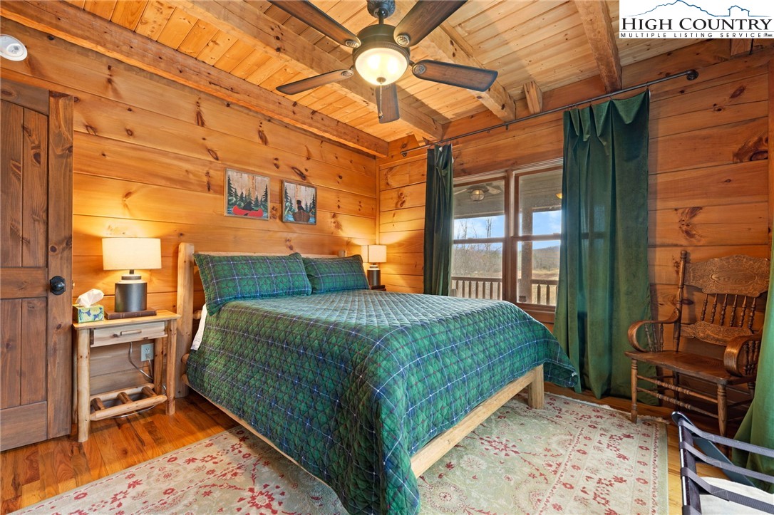 337 Rivers Crest Road Boone, NC 28607 - Photo 16 of 45 a bedroom with a bed and wooden floor