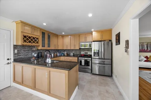 a kitchen with sink a stove and cabinets