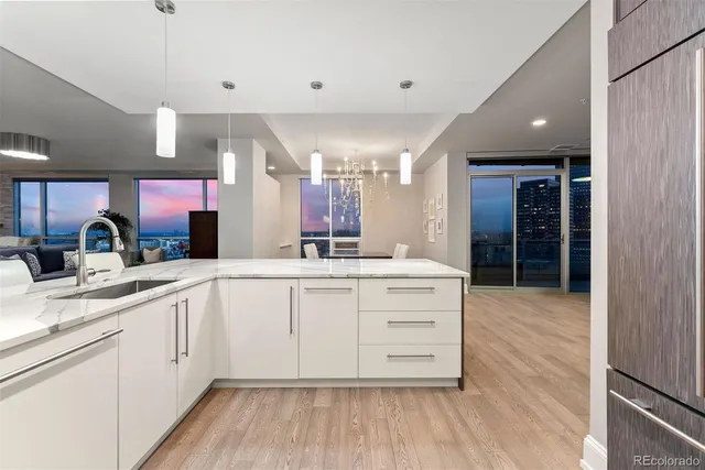 a kitchen with a sink cabinets and wooden floor