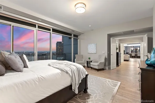 a bedroom with a large bed and a large window