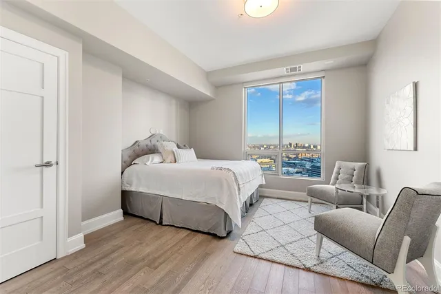 a bedroom with a bed couch and window