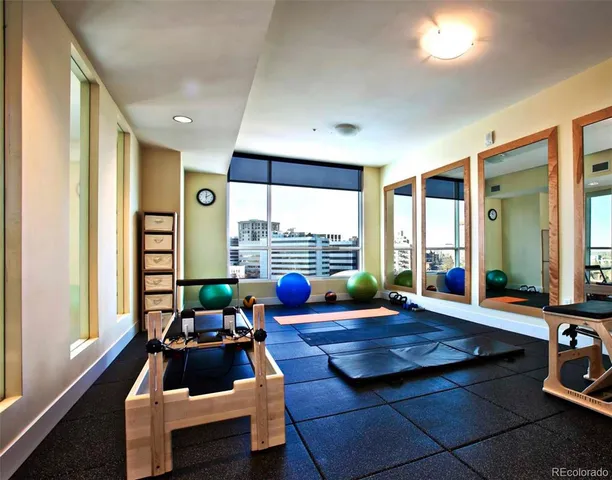 a living room with furniture floor to ceiling window and wooden floor