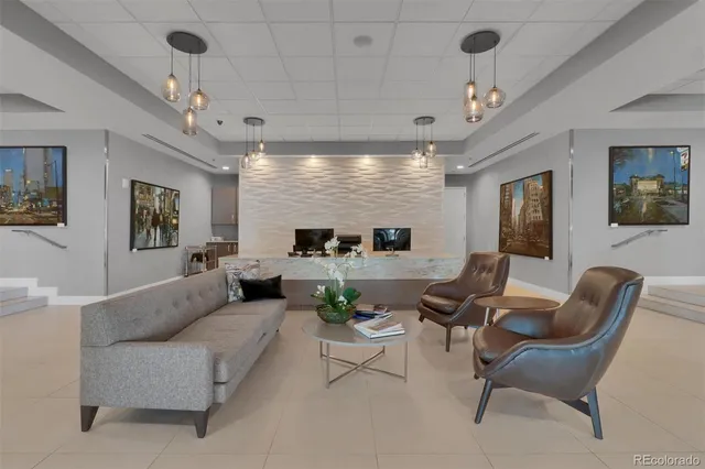 a living room with furniture potted plant and a chandelier