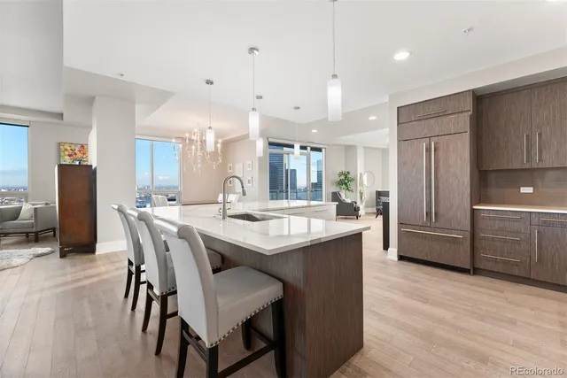 a kitchen with kitchen island a sink stove and refrigerator
