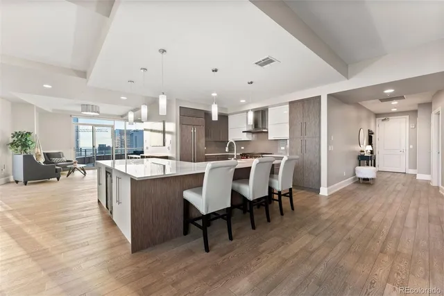 a large kitchen with a table and chairs