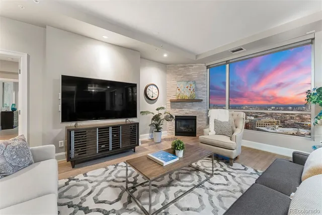 a living room with fireplace furniture and a flat screen tv