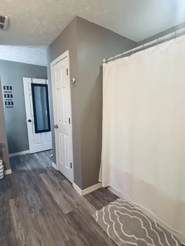 an empty room with wooden floor and a window