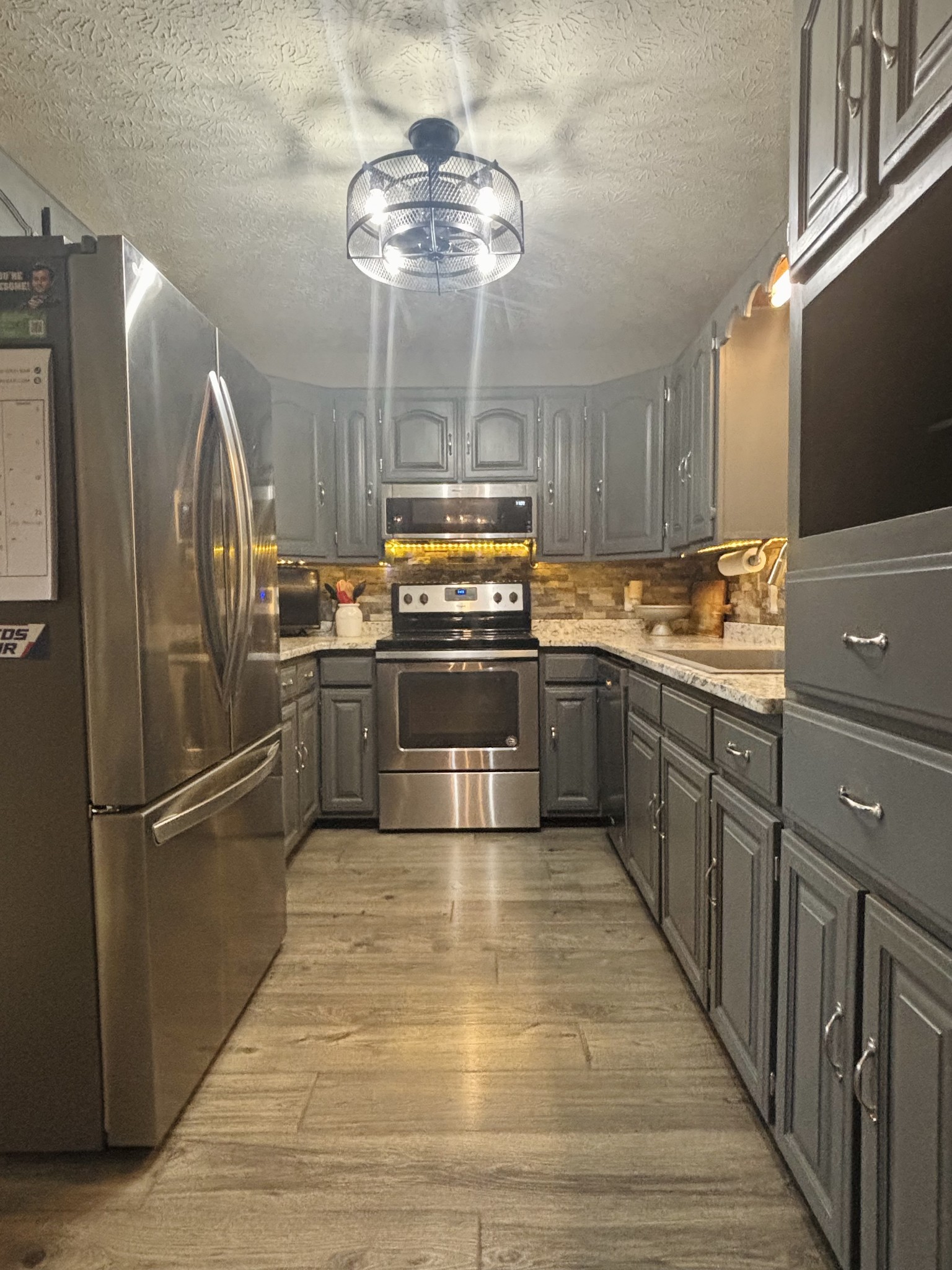 586 Old Snow Hill Road Dowelltown, TN 37059 - Photo 14 of 51 a kitchen with stainless steel appliances granite countertop a sink and a refrigerator
