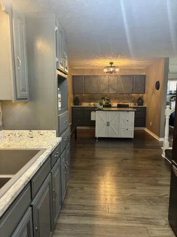 a kitchen with stainless steel appliances granite countertop a sink counter space and stove