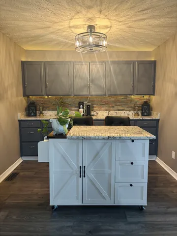 a kitchen with a sink cabinets and wooden floor