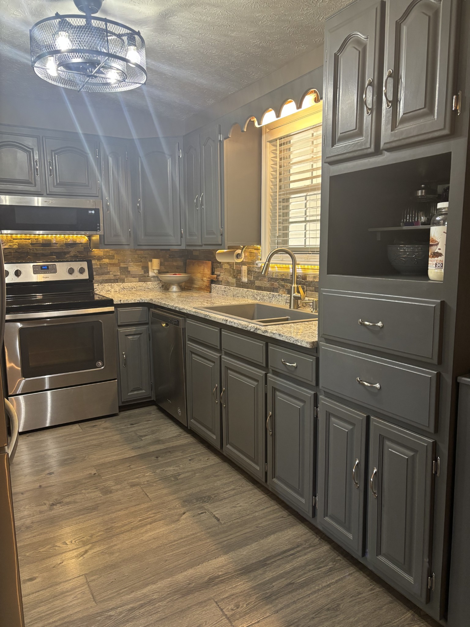 586 Old Snow Hill Road Dowelltown, TN 37059 - Photo 18 of 51 a kitchen with stainless steel appliances granite countertop a stove and cabinets