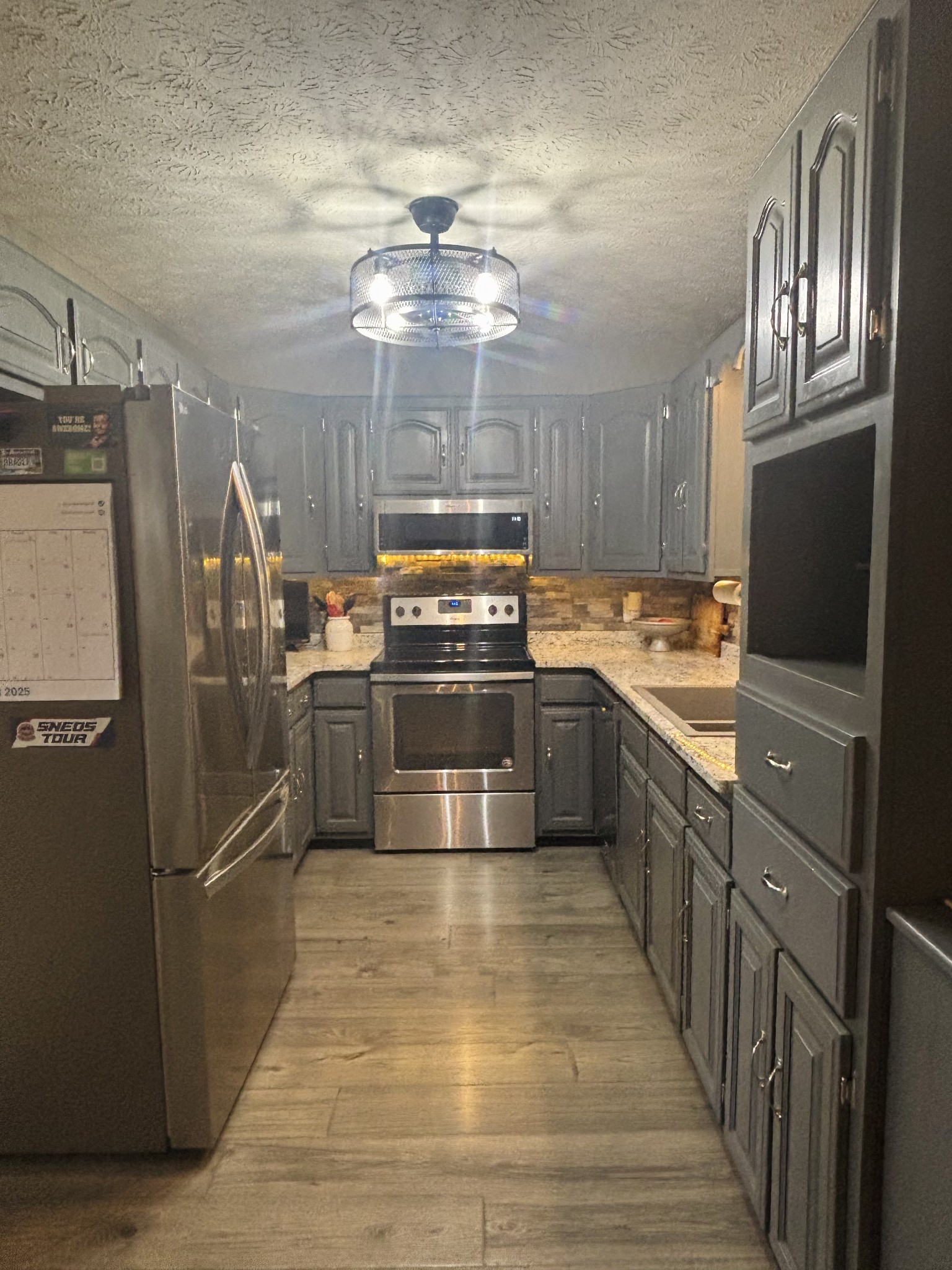 586 Old Snow Hill Road Dowelltown, TN 37059 - Photo 19 of 51 a kitchen with stainless steel appliances granite countertop a sink and refrigerator