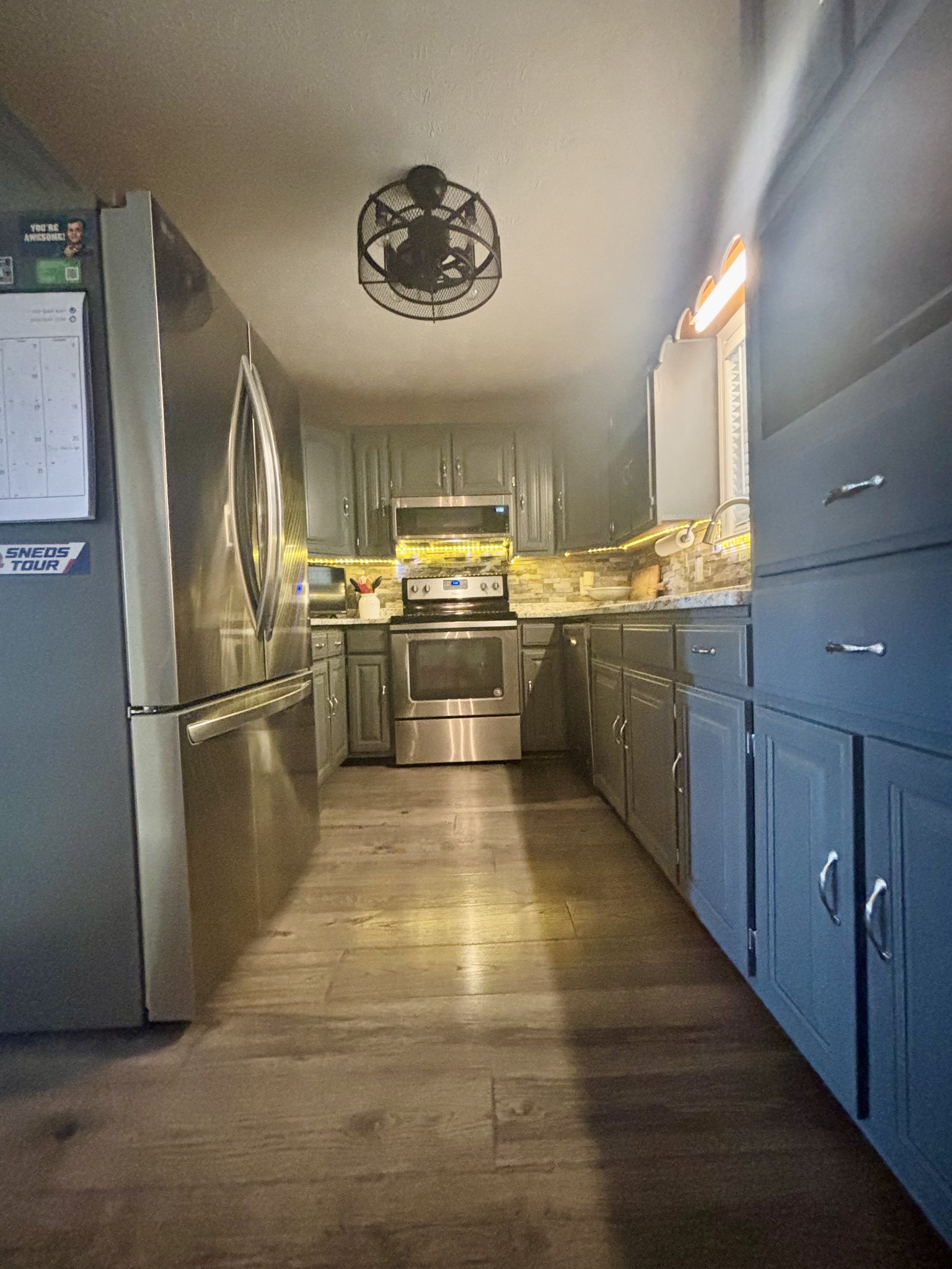 586 Old Snow Hill Road Dowelltown, TN 37059 - Photo 21 of 51 a kitchen with stainless steel appliances granite countertop a refrigerator a sink dishwasher a stove with wooden cabinets