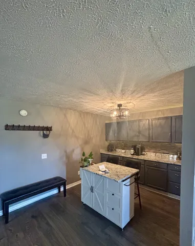 a room with a sink cabinets and wooden floor