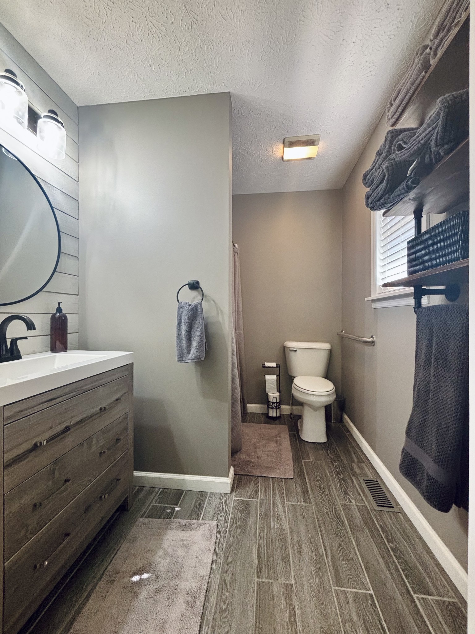 586 Old Snow Hill Road Dowelltown, TN 37059 - Photo 30 of 51 a bathroom with a toilet sink and mirror