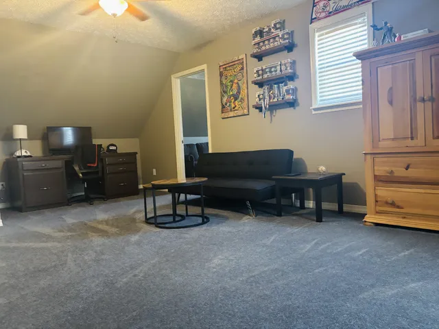 a living room with furniture and a piano