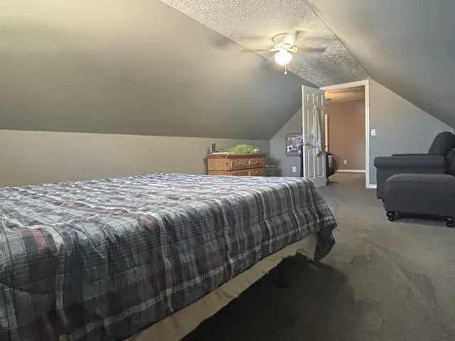 a bedroom with a bed and a couch