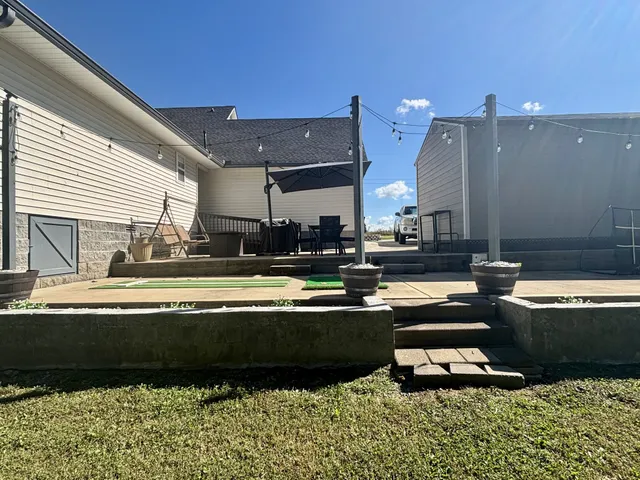 a swimming pool with outdoor seating and yard