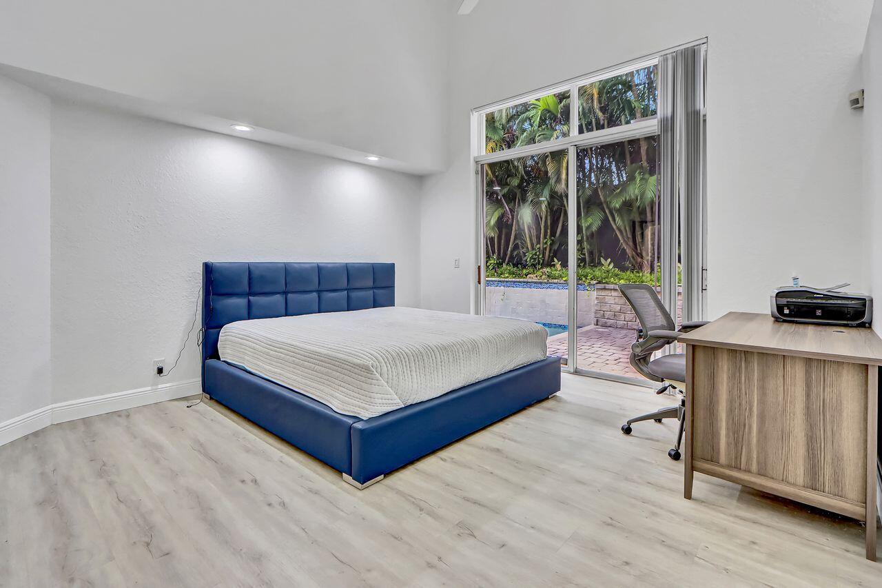 6631 Northwest 43rd Terrace Boca Raton, FL 33496 - Photo 11 of 36 a bedroom with a bed and a window