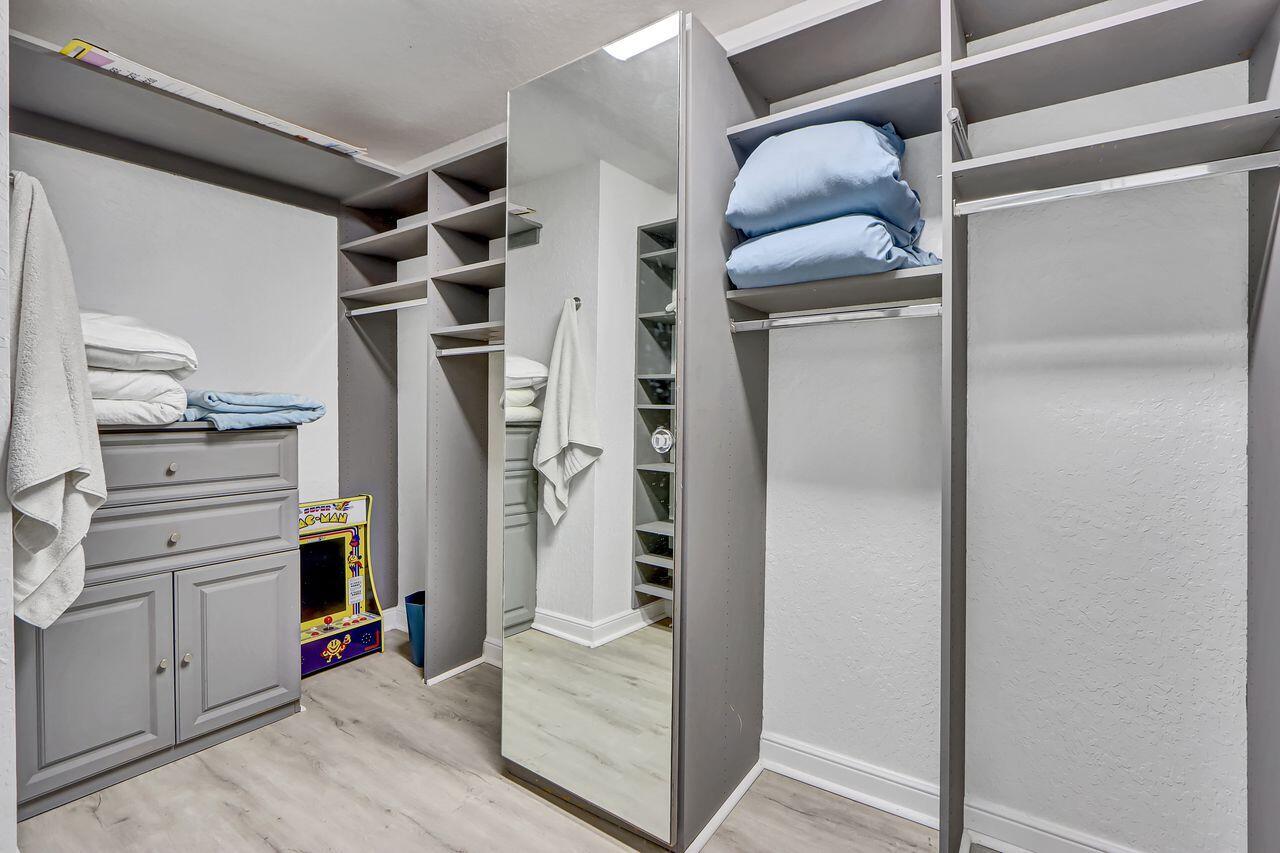 6631 Northwest 43rd Terrace Boca Raton, FL 33496 - Photo 13 of 36 a view of walk in closet with clothes and shoes