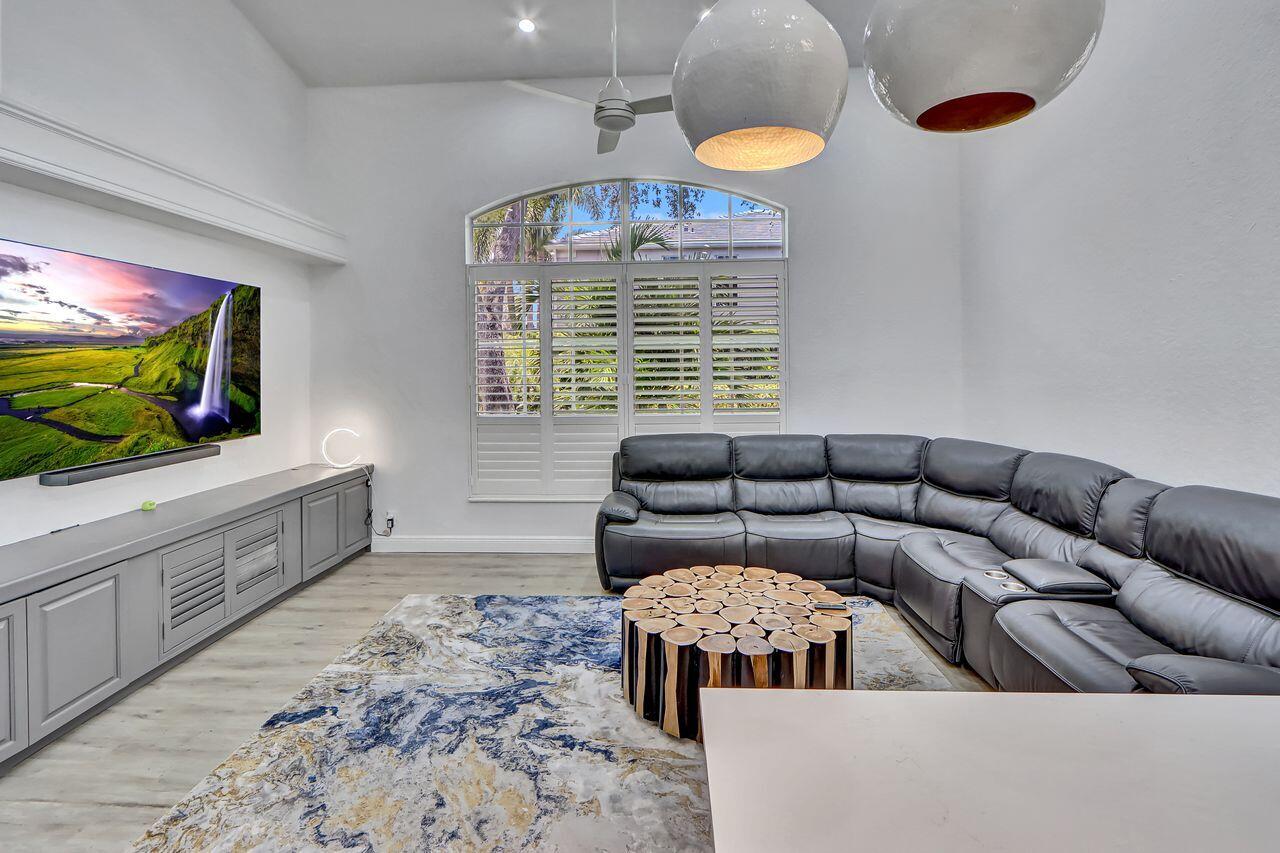 6631 Northwest 43rd Terrace Boca Raton, FL 33496 - Photo 9 of 36 a living room with furniture and a flat screen tv